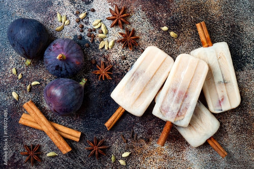 Masala chai popsicles with figs on cinnamon sticks. Spiced ice lollies for fall and winter season. Christmas holiday dessert